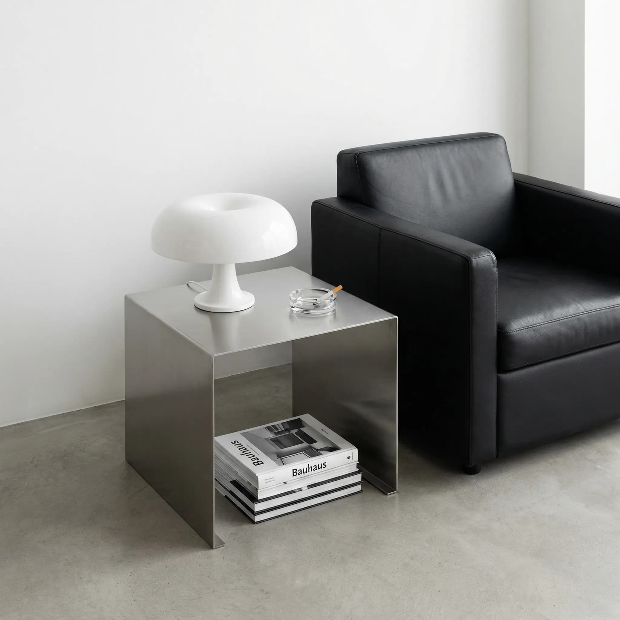 Steel side table with mushroom lamp and Bauhaus books